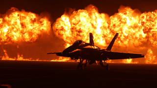 Spectacular photo of an F-18 against a huge wall of fire